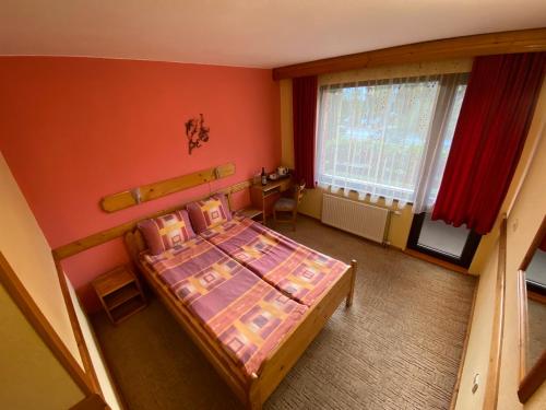 an overhead view of a bedroom with a bed and a window at Family Hotel Savov in Chepelare