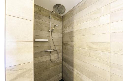 een douche met een douchekop aan de muur bij Ferienwohnung Meersinn in Wustrow