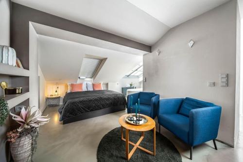 a bedroom with a bed and a blue chair at Amazing Apartment in Prague