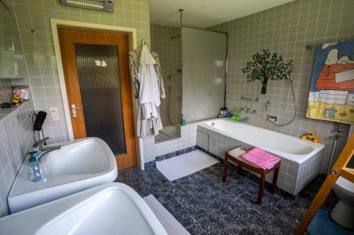 a bathroom with a tub and a sink and a bath tub at Nature Paradies am Seeberg in Heidenheim an der Brenz