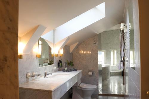 a bathroom with a sink and a toilet at Grand Hotel Saltsjöbaden in Saltsjöbaden