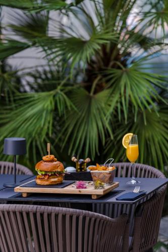 a table with a plate of food on top at Hotel Lero in Dubrovnik