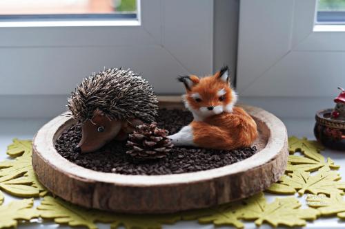 a small figurine of a fox and a hedgehog at SOLEK Apartamenty i pokoje gościnne in Mielno