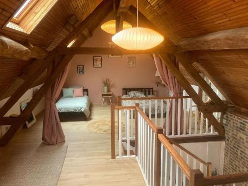 salon z drewnianym sufitem i schodami w obiekcie Longère de charme w mieście Saint-Cyran-du-Jambot