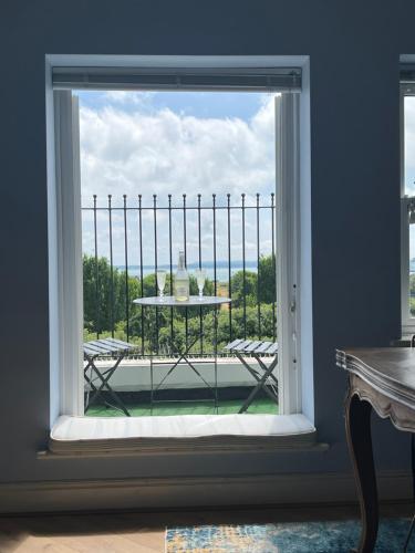 a window with a table looking out at a balcony at Skyline Oasis in Portsmouth
