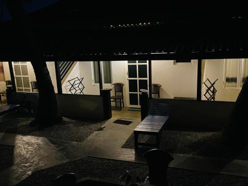 a night view of a patio with a table and chairs at Winston Sea Front Villa in Negombo