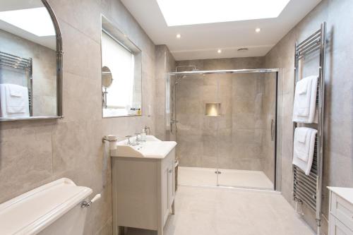 a bathroom with a shower and a sink and a tub at Cornish Views in Camborne