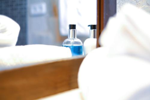 a close up of two bottles of soap in front of a mirror at Finca Can Toni in Sant Jordi