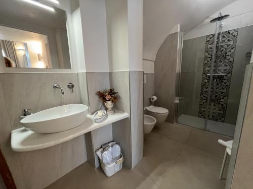 a bathroom with a sink and a shower and a toilet at Palazzo Marisa in Fasano