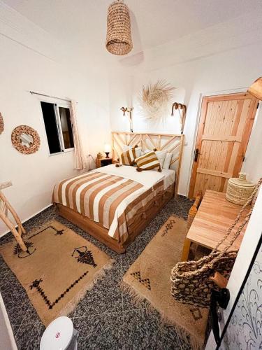 a bedroom with a bed in a room at Paddle Out Morocco in Tamraght Ouzdar