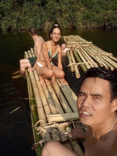 a group of people sitting on a raft in the water at Bee Bee's Chalets home stay and trekking in Banlung