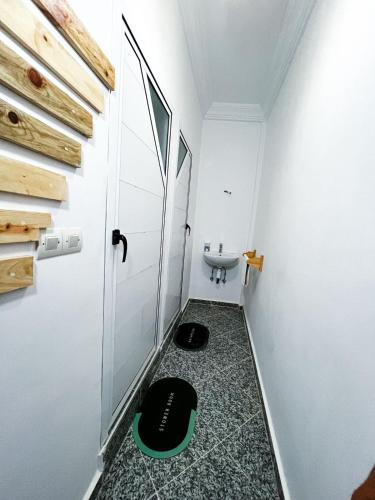 a small bathroom with a sink and a toilet at Paddle Out Morocco in Tamraght Ouzdar