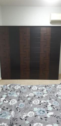 a bedroom with a bed with a black and white blanket at HOUSE IN AL AIN in Al Ain