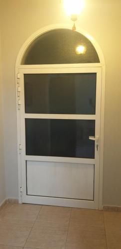 a white door with a light on top of it at HOUSE IN AL AIN in Al Ain