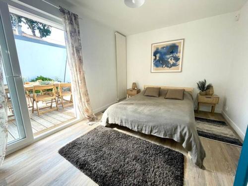 une chambre avec un lit et une grande fenêtre dans l'établissement Villa à la Baule Annabelle, à La Baule