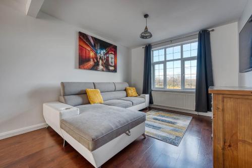 a living room with a couch and a window at 2 Bedroom Bungalow with Garden and Parking in Radcliffe on Trent
