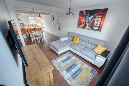 a living room with a couch and a table at 2 Bedroom Bungalow with Garden and Parking in Radcliffe on Trent