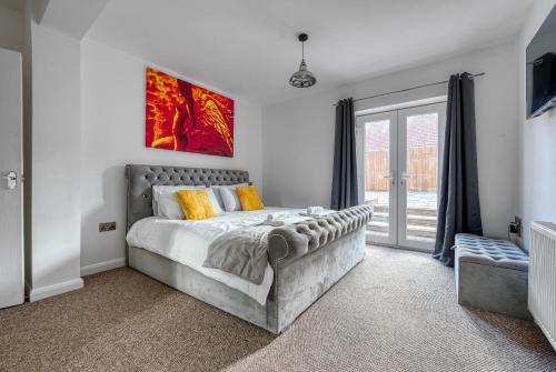 a bedroom with a bed and a large window at 2 Bedroom Bungalow with Garden and Parking in Radcliffe on Trent