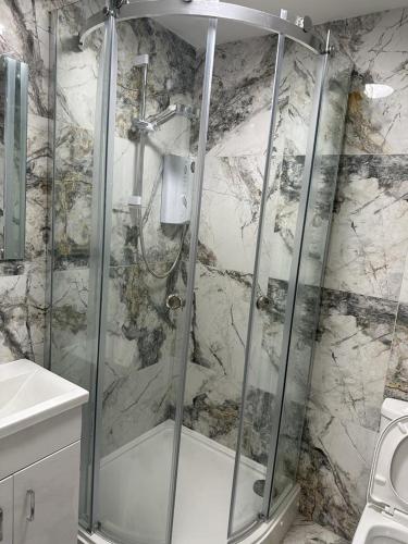 a shower with a glass door in a bathroom at 1GS Luxury London Road Apartments in Leicester
