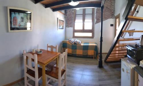 uma sala de estar com uma mesa e uma cama num quarto em The Rustic Hause 2 em Gualeguay