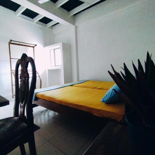 a bedroom with a bed in a room with a chair at Glance Beach Ahangama in Ahangama