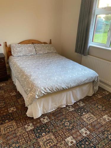 A bed or beds in a room at Country House 20 minutes to Galway City