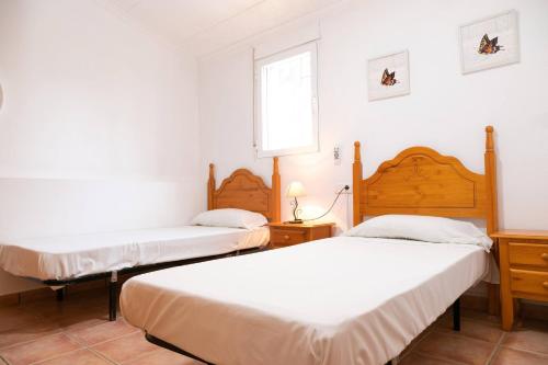 1 dormitorio con 2 camas y ventana en Quet - Casa rural con piscina privada en el Delta del Ebro - Deltavacaciones, en Deltebre