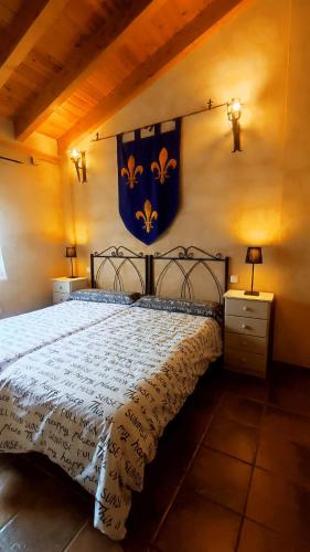 a bedroom with a bed and a flag on the wall at LAS CALLEJUELAS in Atienza