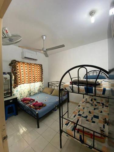 a room with two bunk beds and a ceiling at Gayang Tuaran in Tuaran