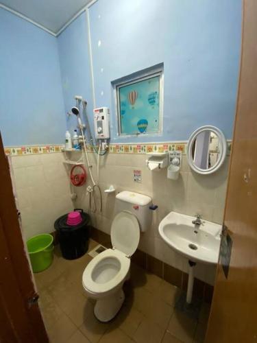 a small bathroom with a toilet and a sink at Gayang Tuaran in Tuaran
