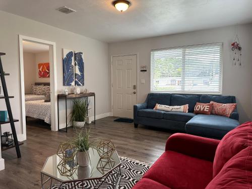 a living room with a blue couch and a bed at PARADISE II MIAMI BEACH HOUSE in Miami