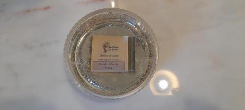 a plate with a book on it with a candle at Quinta Alto da Fraga in Vila Nova de Foz Coa
