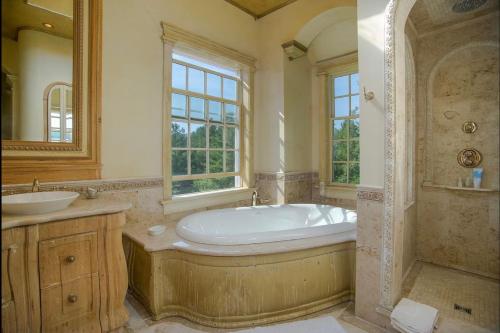 baño grande con bañera y lavamanos en Adams Hill House Retreat - Artist-Architect's Estate, Newfane Vermont, en Newfane