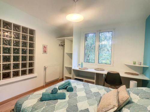 um quarto com uma cama, uma secretária e uma janela em Les Goujatoux chambre les Eyzies em Coursac