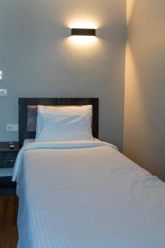 a bedroom with a white bed with a light above it at BRANDROOM HOTEL in Istanbul