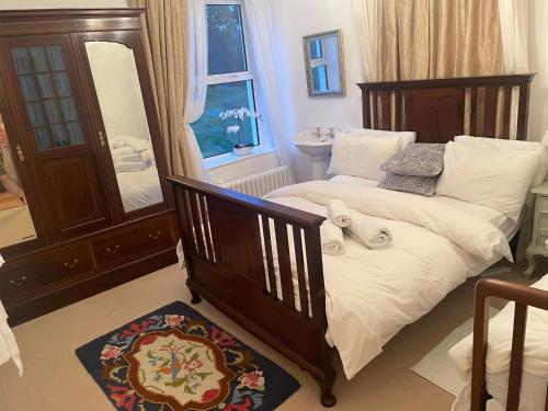 a bedroom with a bed with a mirror and a sink at Brackfield House Deal 49 in Killaloo