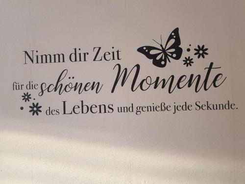 a sign with a butterfly on a wall at FeWo Weimar in Weimar