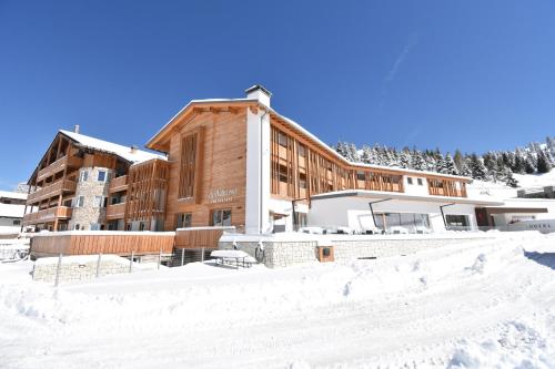 a large building in the snow with snow covered grounds at Hotel La Baita in Folgaria