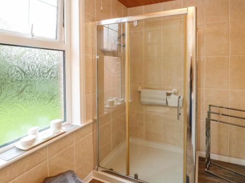 a shower with a glass door in a bathroom at Tidal Reach in Paignton