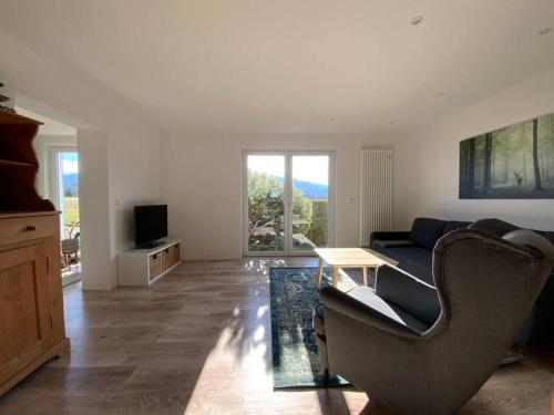 a living room with a couch and a table at Ferienwohnung in Stegen bei Freiburg, Schwarzwald in Stegen