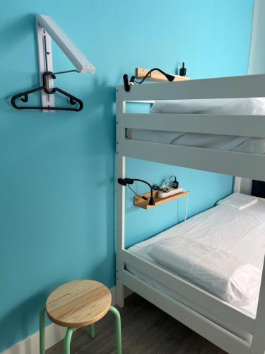 a bunk bed with a table and a desk at East Harlem Hostel in New York