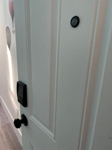 a white door with a black door knob at East Harlem Hostel in New York