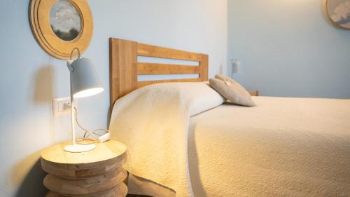 a bedroom with a bed and a table with a lamp at Azienda agricola La Macina in Bregnano