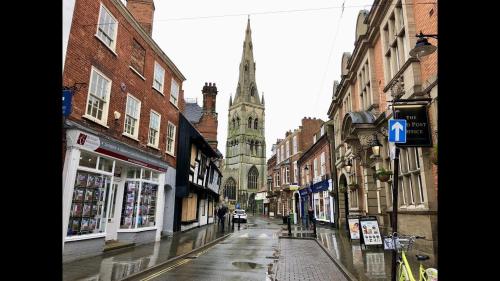 an empty city street with a church in the distance at Kings Sconce in Newark upon Trent
