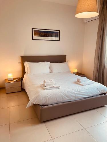 a bedroom with a bed with two towels on it at Berga Exclusive Suite 5 in Bari