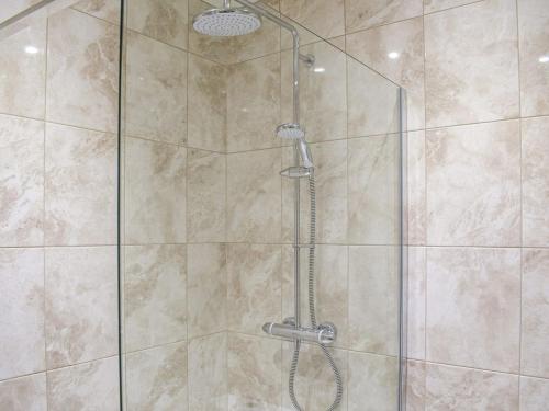 a shower stall with a glass shower door at The Lookout - Uk35022 in Hope under Dinmore