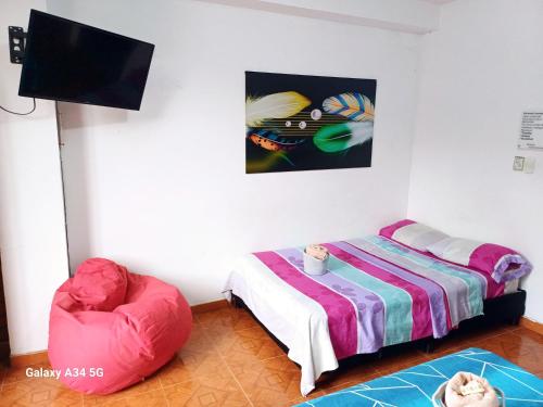 En eller flere senger på et rom på Confort Putumayo