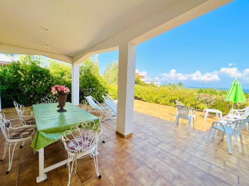 a patio with a table and chairs and a view at Villa Giada in Carini