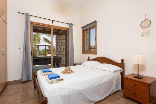 a bedroom with a bed with towels on it at Villa Windmill in Polis Chrysochous