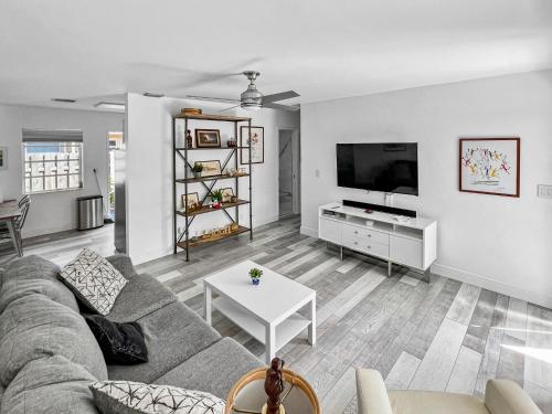 a living room with a couch and a tv at Stylish & Cozy Home Close To Beach- Free Parking, Private, Backyard, Laundry in Pompano Beach